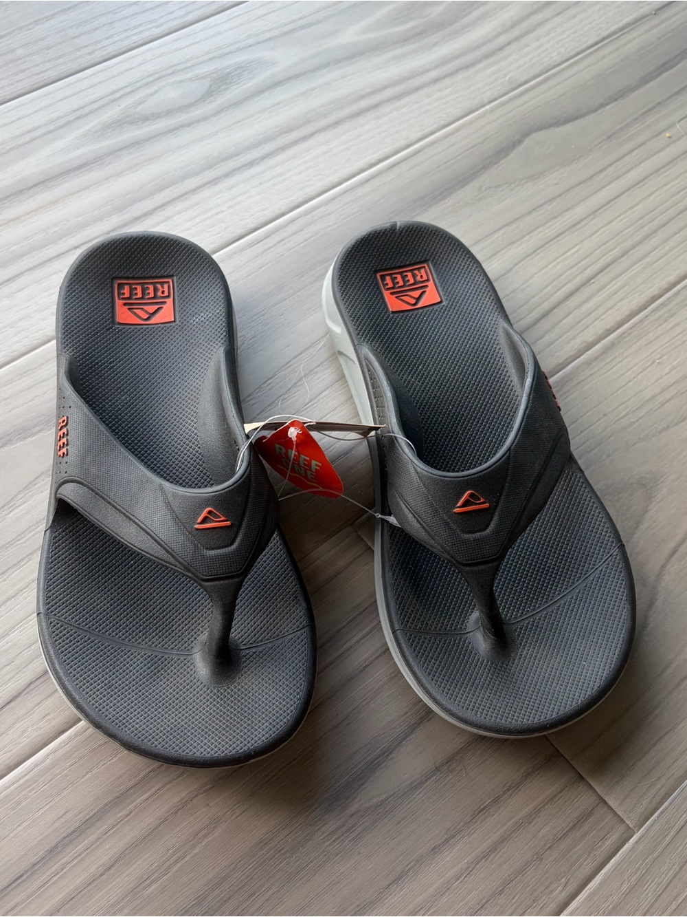 Reef Men's Black and Gray Flip-Flops with Orange Logo Accents